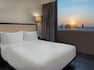 Bed in Guest Room with City View