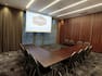 Chairs and U-Shaped Table with Projector Screen in Conference Room