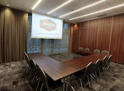 Conference Room with Three Tables and Projector Screen