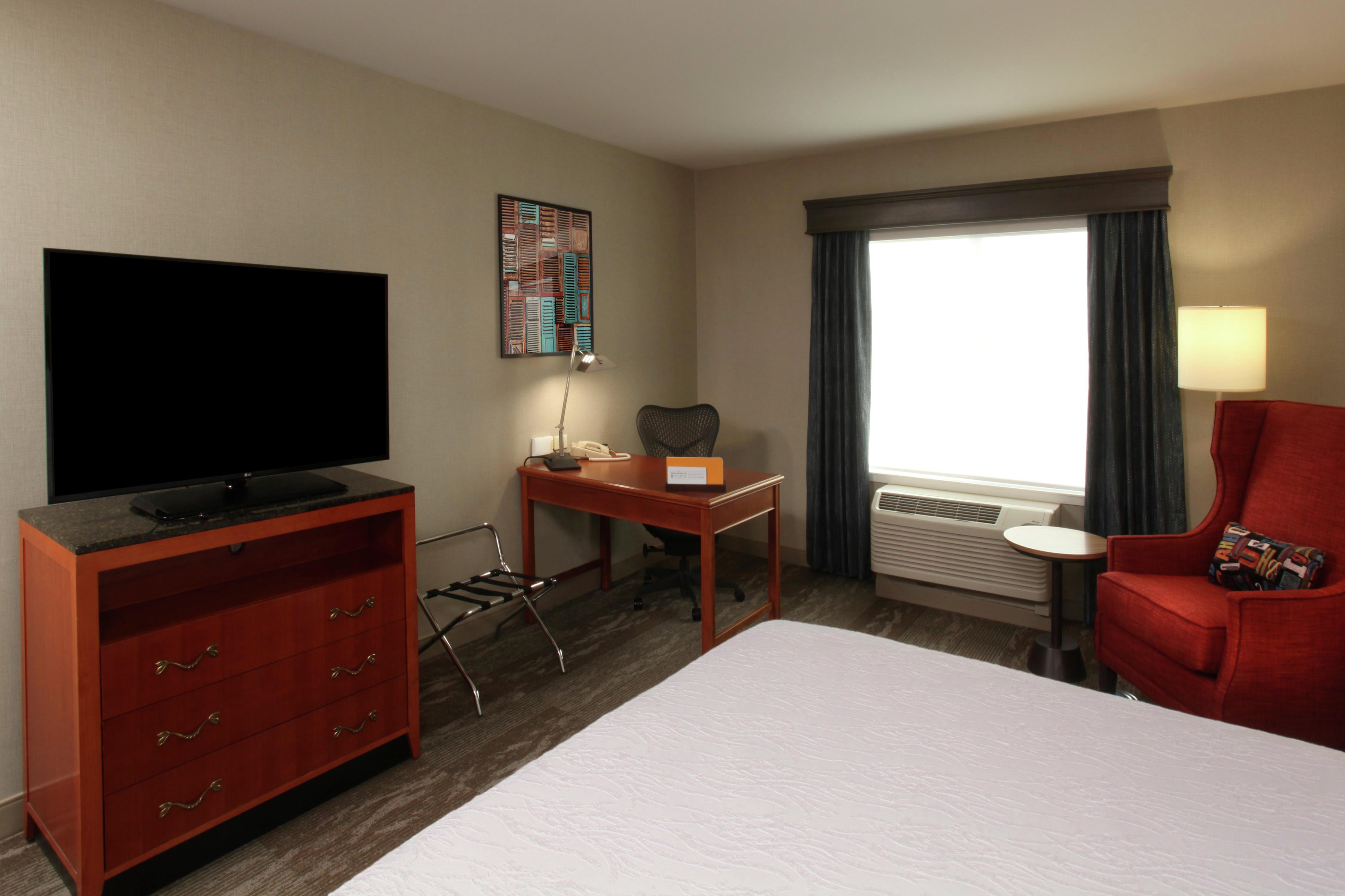 One King Bed Guest Bedroom with HDTV, Work Desk and Armchair