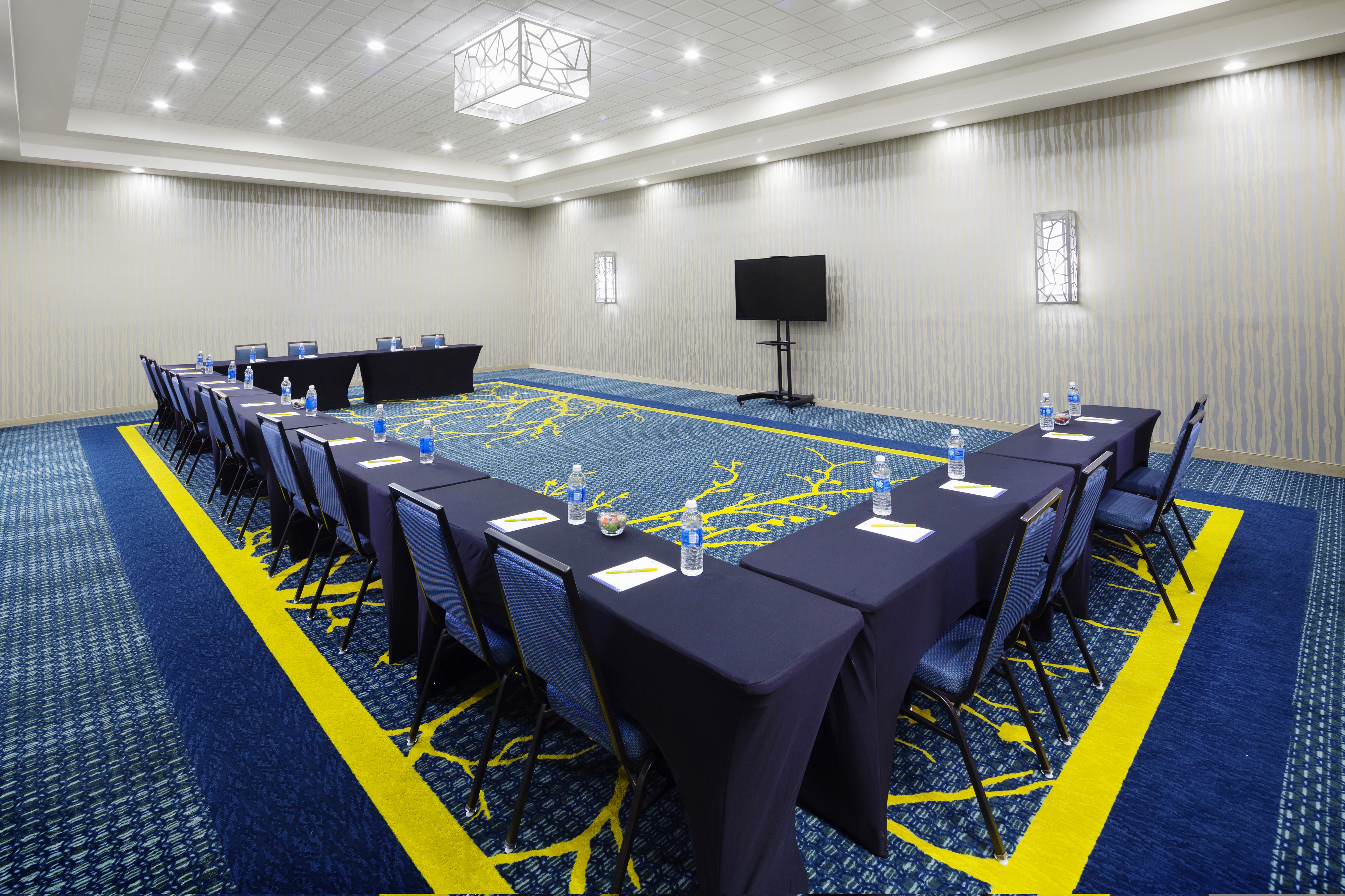 Meeting room with tables arranged in a U shape  