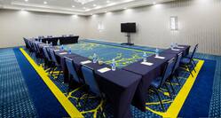 Meeting room with tables arranged in a U shape  