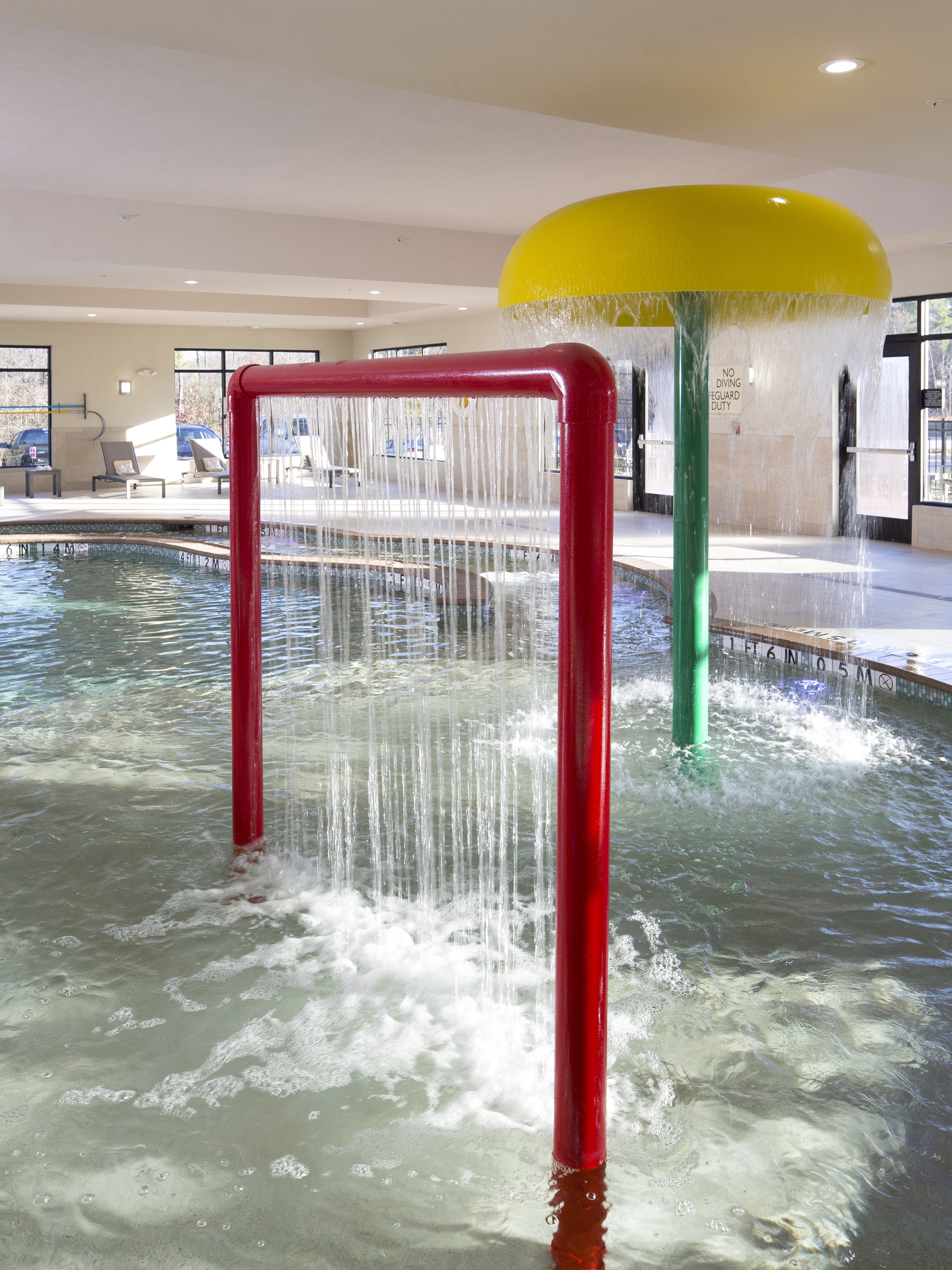 Indoor pool at hotel with water features.