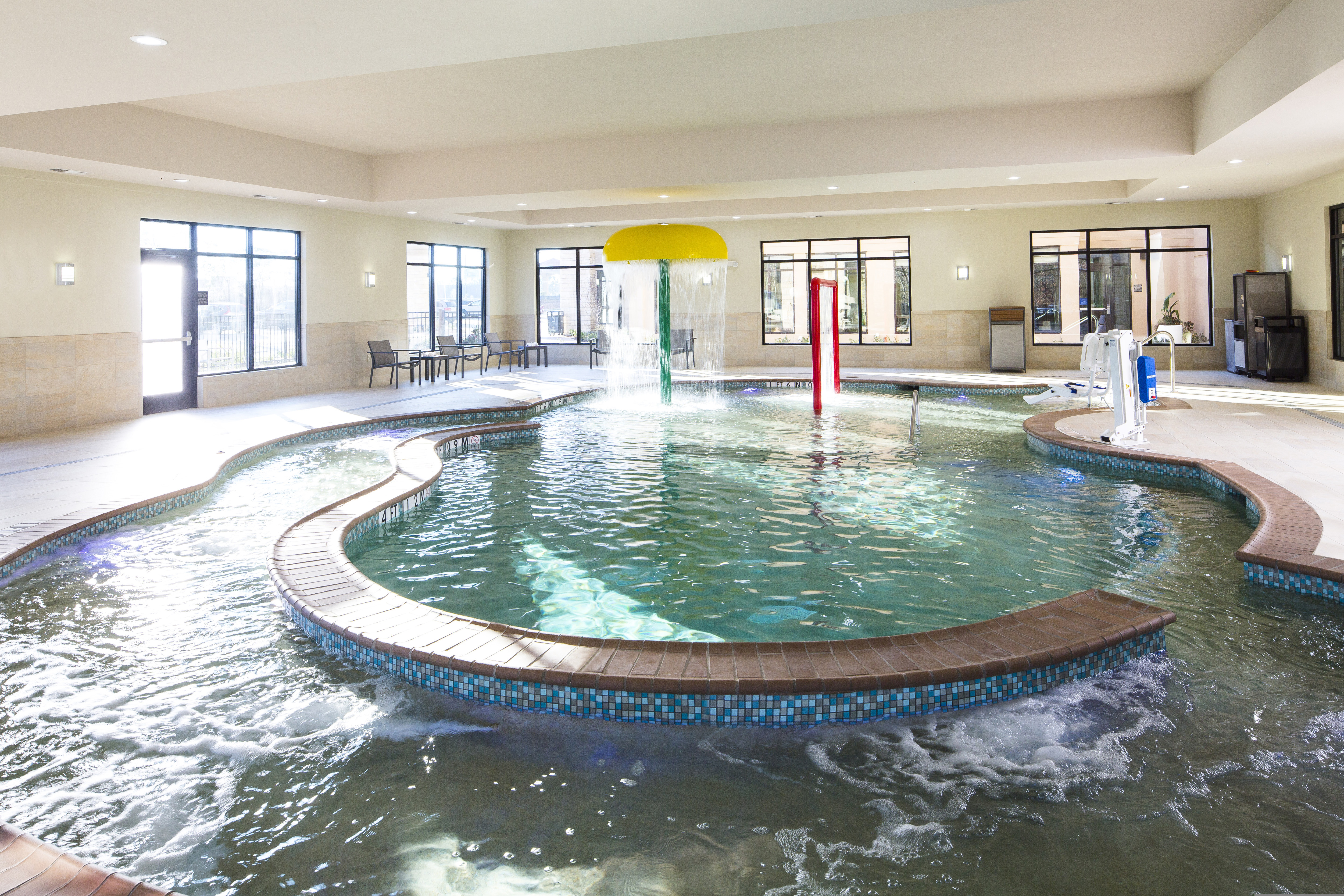 Indoor pool with water features.