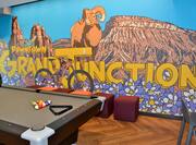 Pool table with mural in background
