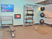 Fitness center with bench and ketltle bells