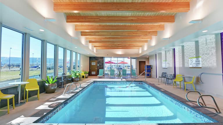 Indoor Pool and Lounge Area with Wood Beam Ceiling