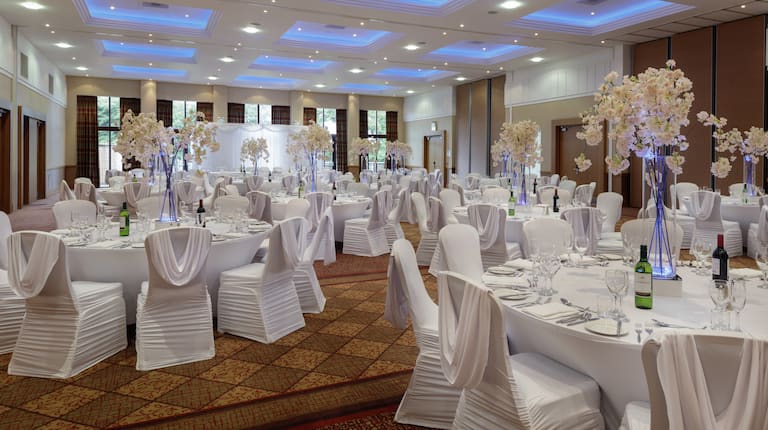 Ballroom Area with Round Tables and Chairs in Wedding Reception Setup