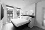 A hotel room with a city view.