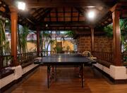 a covered recreational space with table tennis