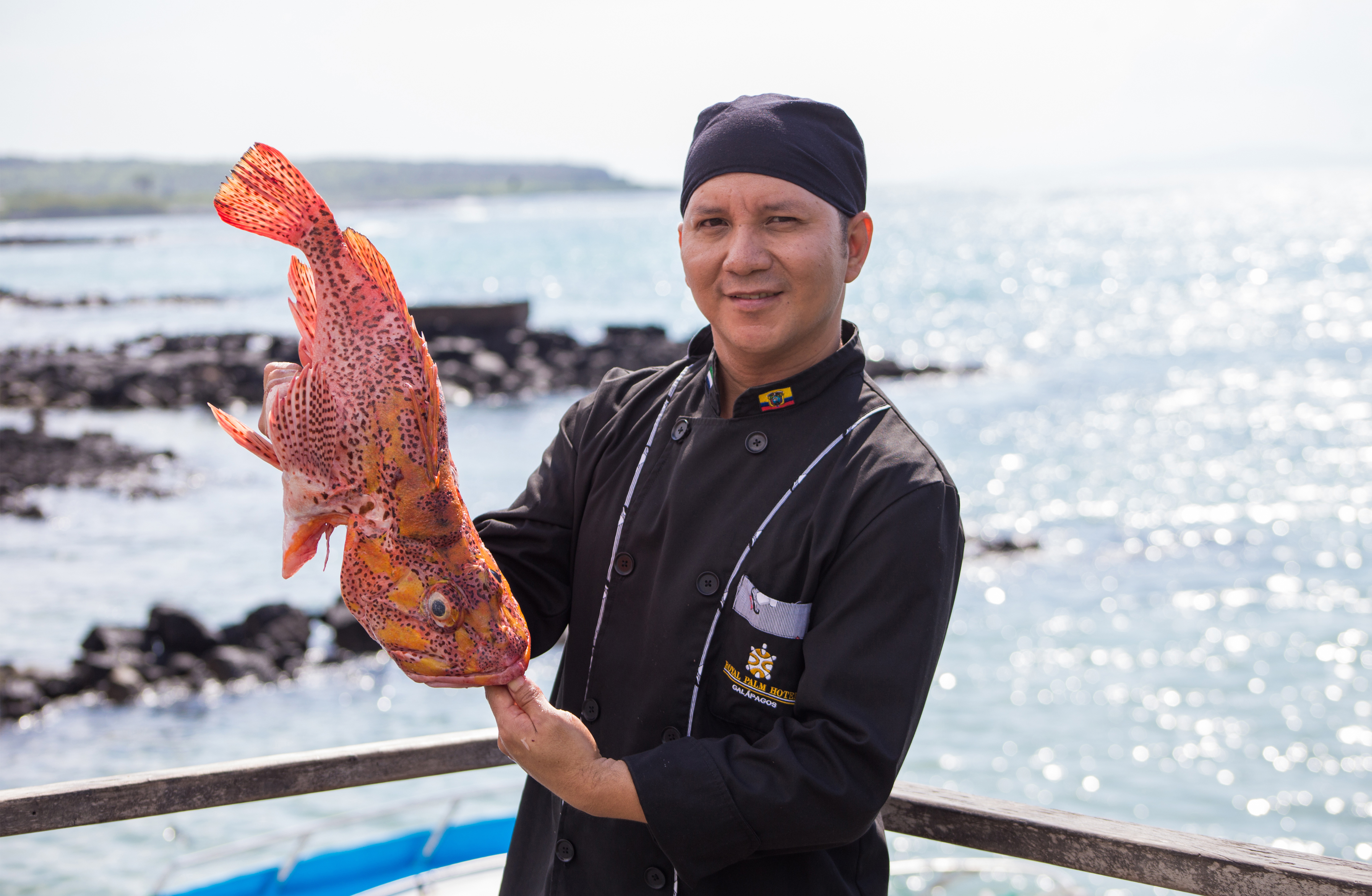 Chef holding a dead fish