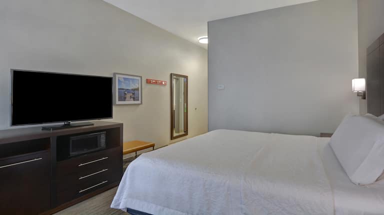 guest room with bed and television