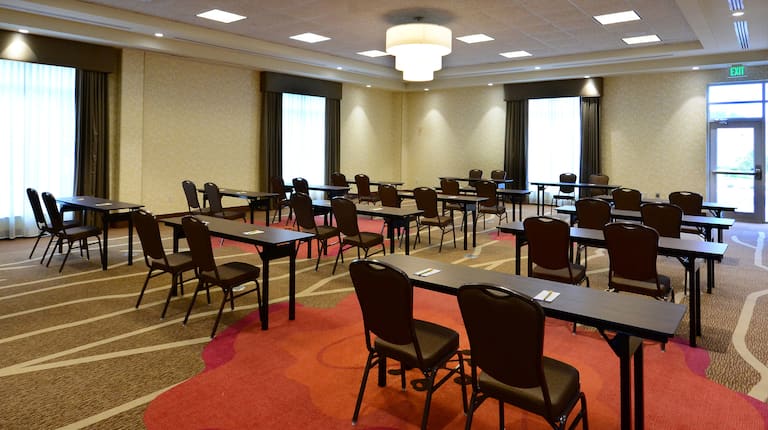 meeting room with rows of tables and chairs