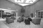 Lobby Seating Area, Font Desk, Window With Closed Drapes, and Entrance at NIght