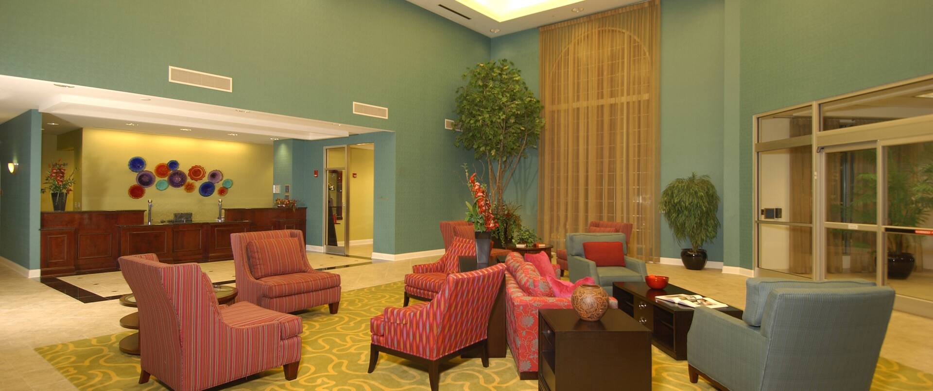 Lobby Seating Area, Font Desk, Window With Closed Drapes, and Entrance at NIght
