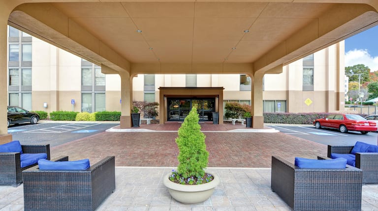 Hotel Exterior with Outdoor Seating and Front Entrance