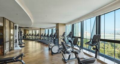 Modern Equipment in Fitness Center with Large Windows