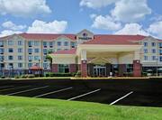 Daytime View of Hotel Exterior, Front Entrance, and Empty Parking Lot
