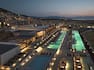 aerial view of hotel and outdoor pools at dusk