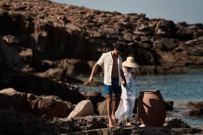 Couple Walking on Rocks at the Beach