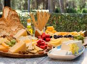 Cheese platter with multiple cheeses and breads