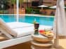 outdoor pool with fruit and beverage by lounge chair