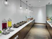 Breakfast Bar Area with Fruits Drinks and Hot Foods