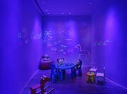 Room with purple lighting and kids toys