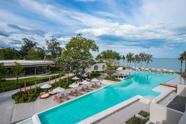 Outdoor swimming pool with loungers and parasols