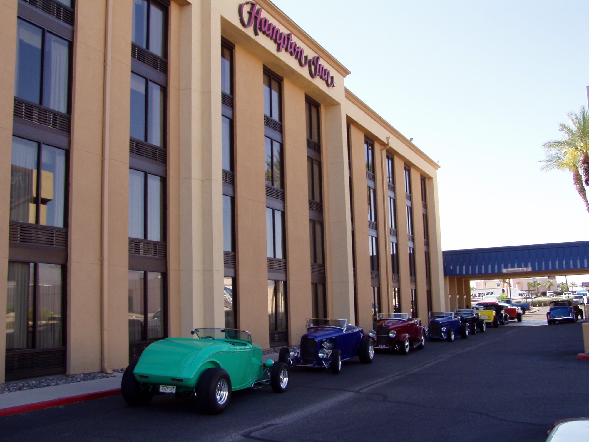 Hotel Exterior with Hot Rods parked in Front 