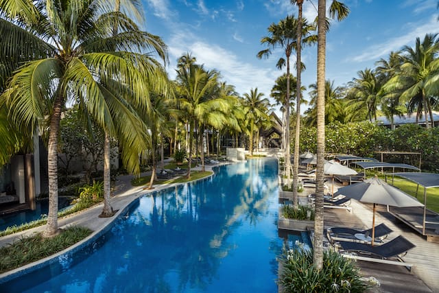 Outdoor swimming pool with loungers and parasols