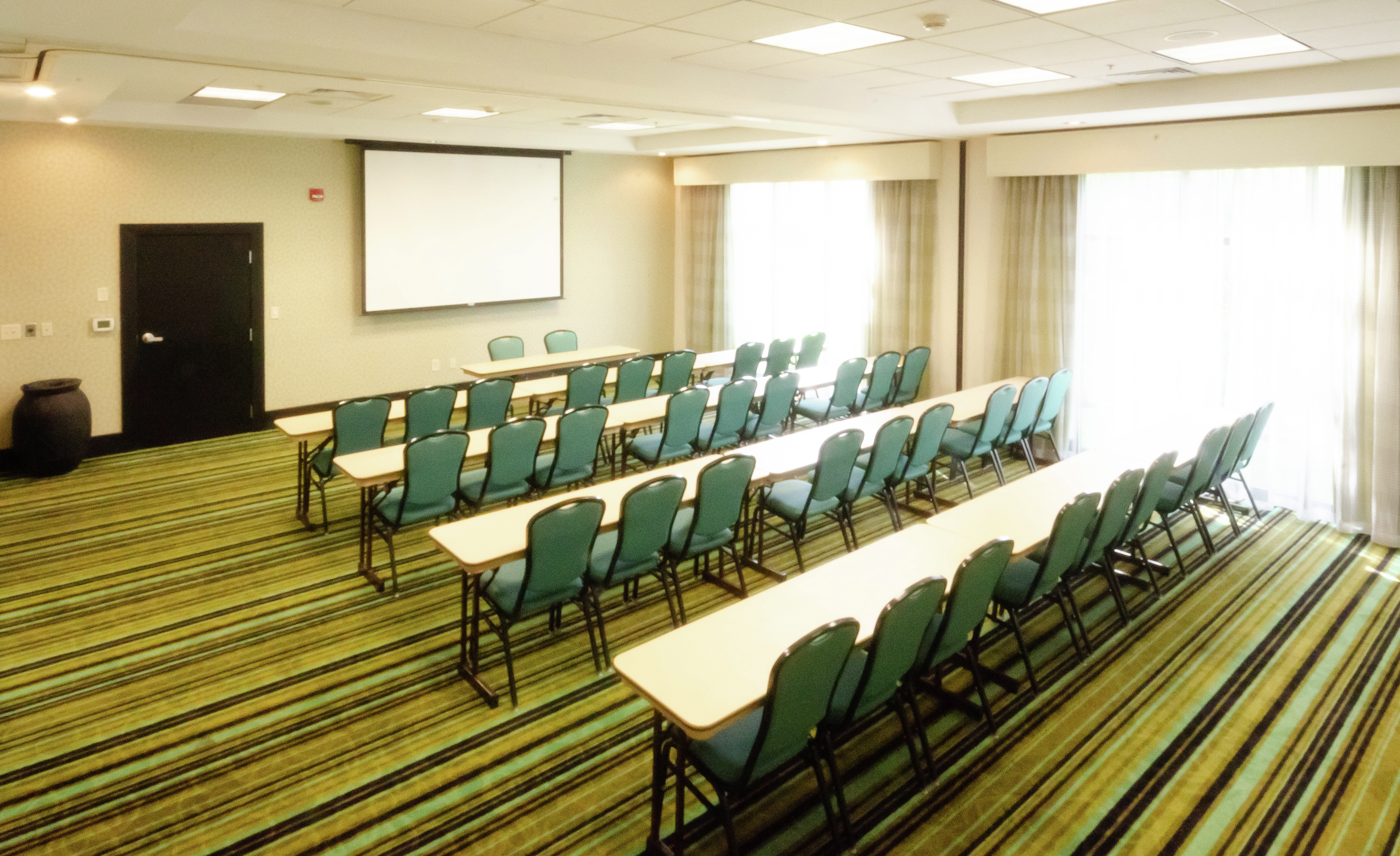 Meeting Room with Seating Facing a Projector Screen