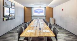 Meeting Space with Boardroom Seating and Projection Screen