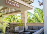 Pakini Bar Sign and Seating by Trees