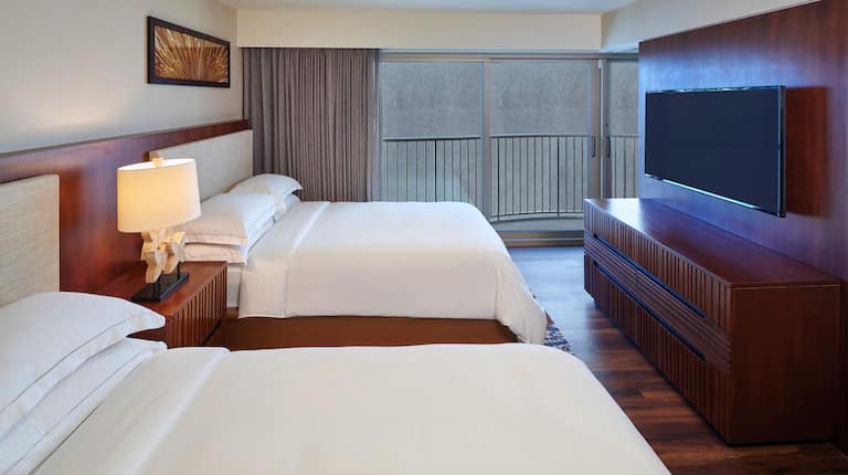 2 beds in room with TV