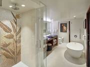 Bathroom with tub and mirror