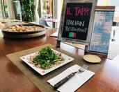 Sign, menu, and place setting at table with Octopus Carpaccio at Il Tapo