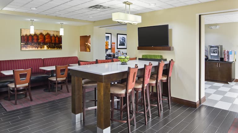 Breakfast Dining Area with Tables, Chairs and Wall Mounted HDTV