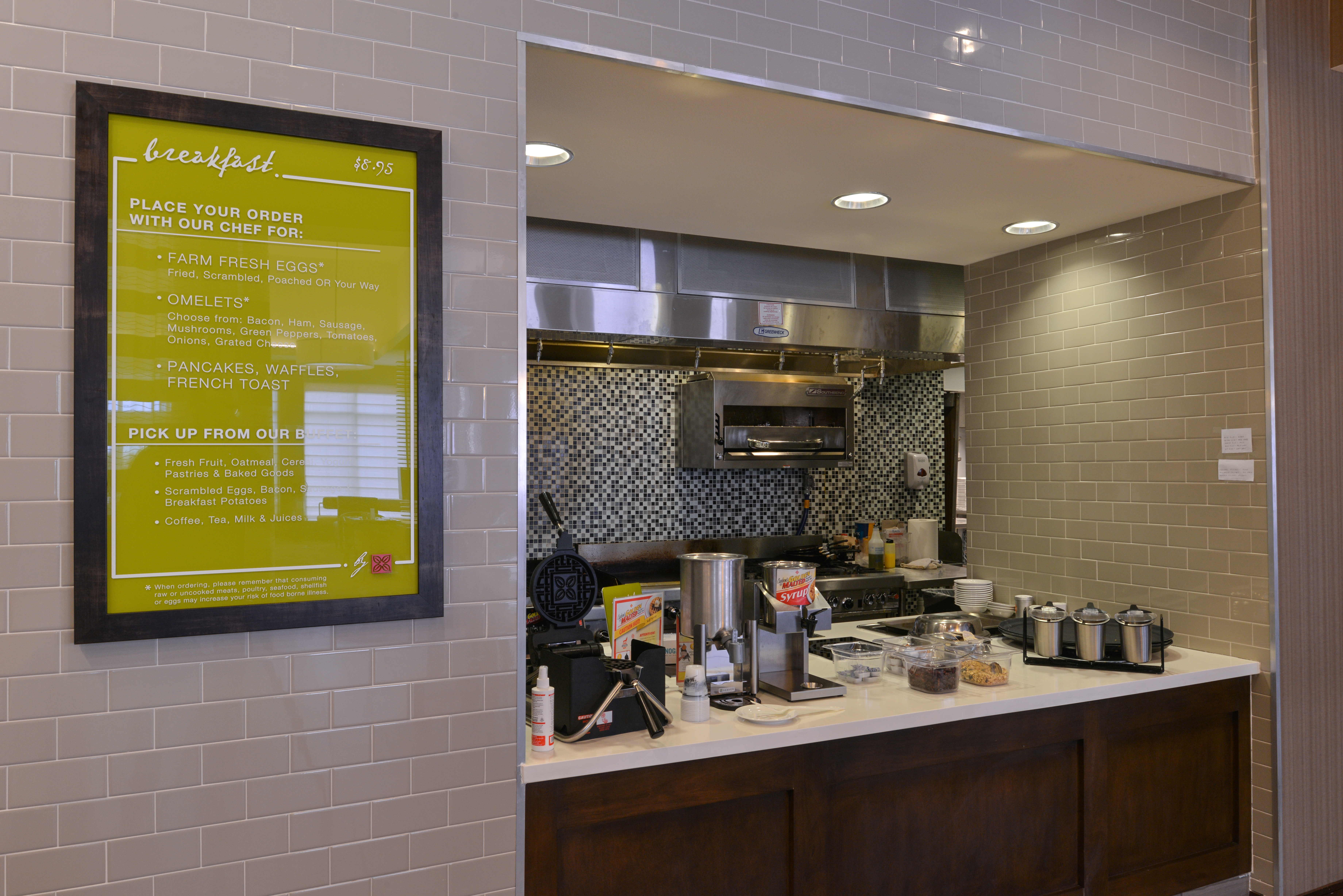 Buffet Selection in Breakfast Area with Menu Signage, Waffle Iron, and Condiments