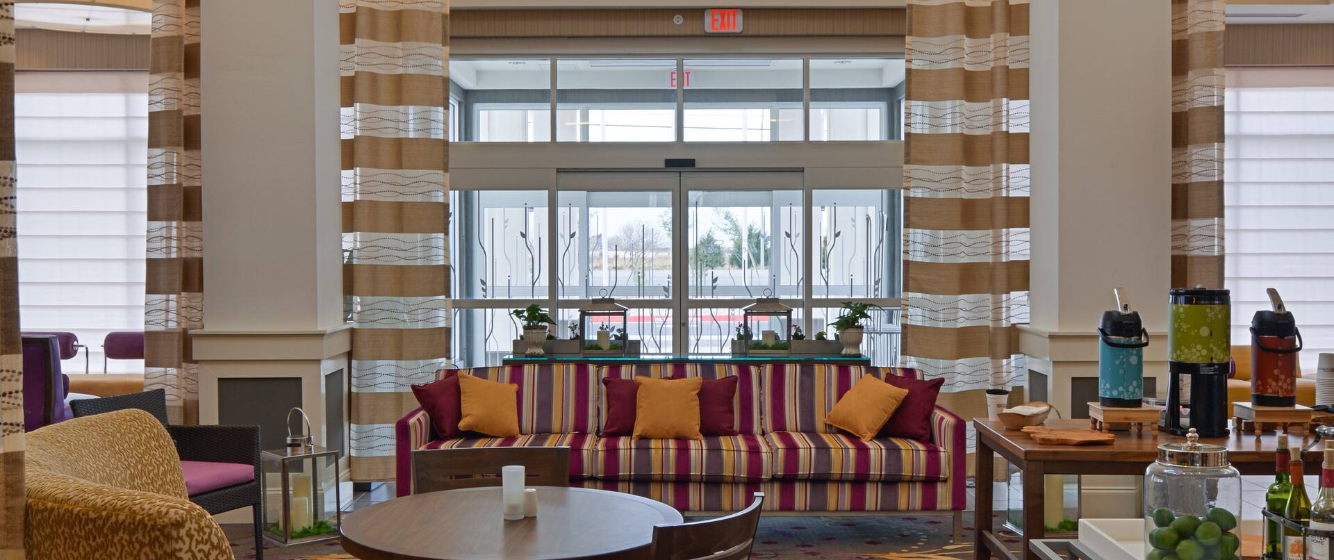Lobby Sitting Area With Sofa, Table, Chairs, and Beverage Station