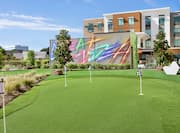 Putting Green On-Site with Hotel Exterior