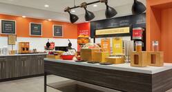 Bright breakfast serving area featuring complimentary daily buffet overflowing with delicious food and beverages.
