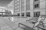 Loungers alongside outdoor pool with handrails
