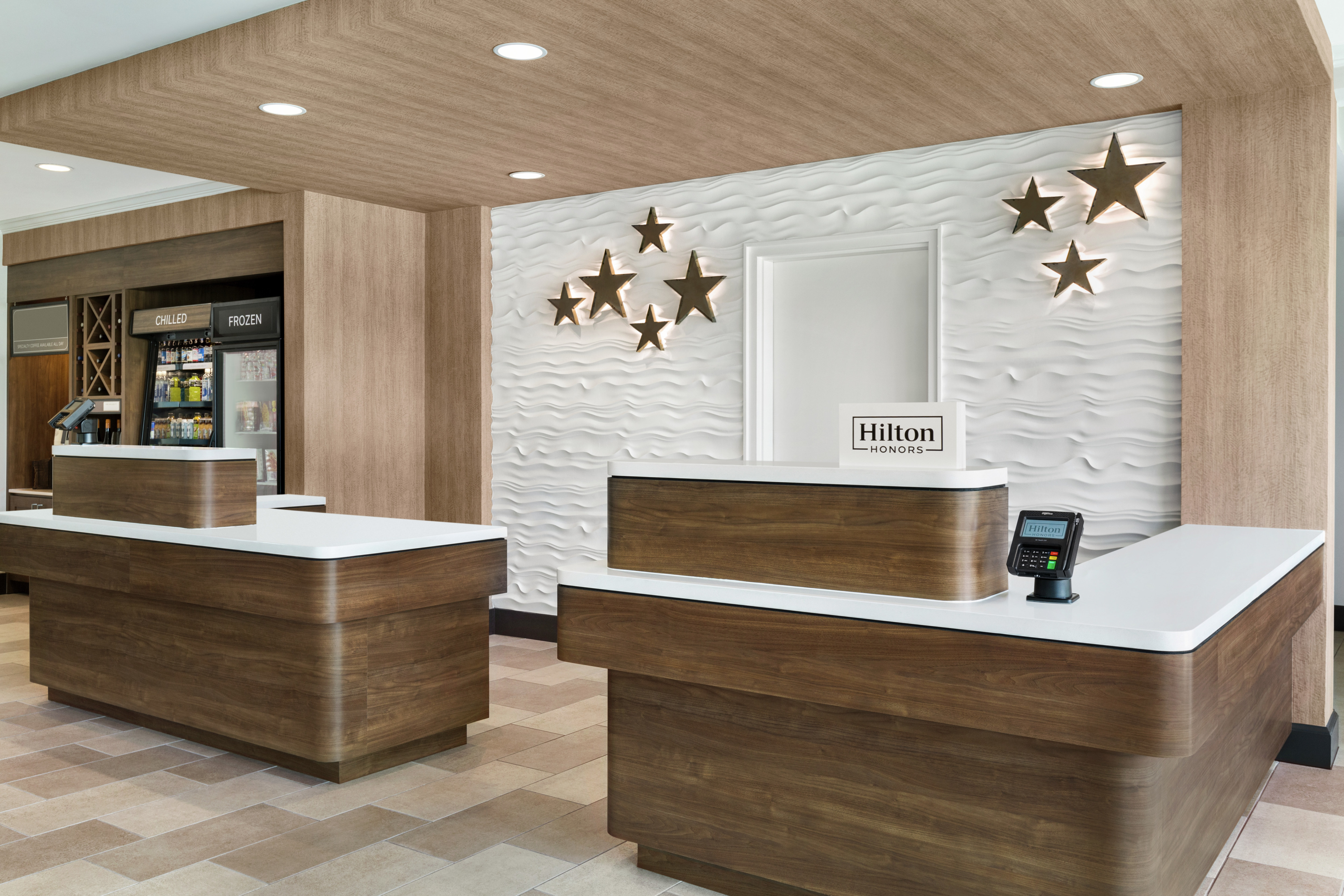 Welcoming hotel front desk featuring stunning design and convenient snack shop.