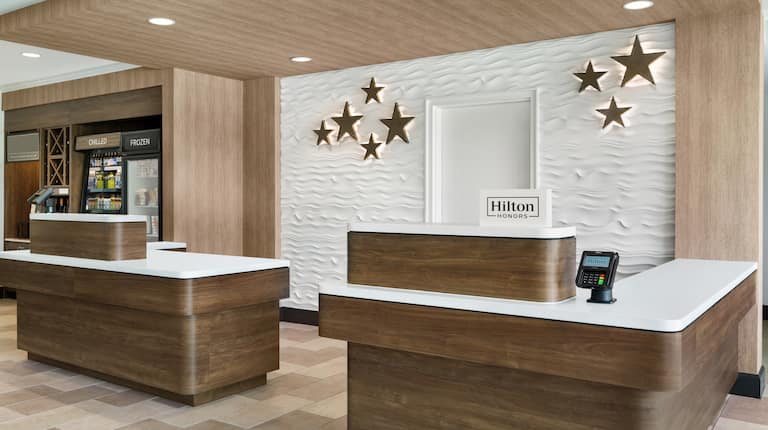 Welcoming hotel front desk featuring stunning design and convenient snack shop.