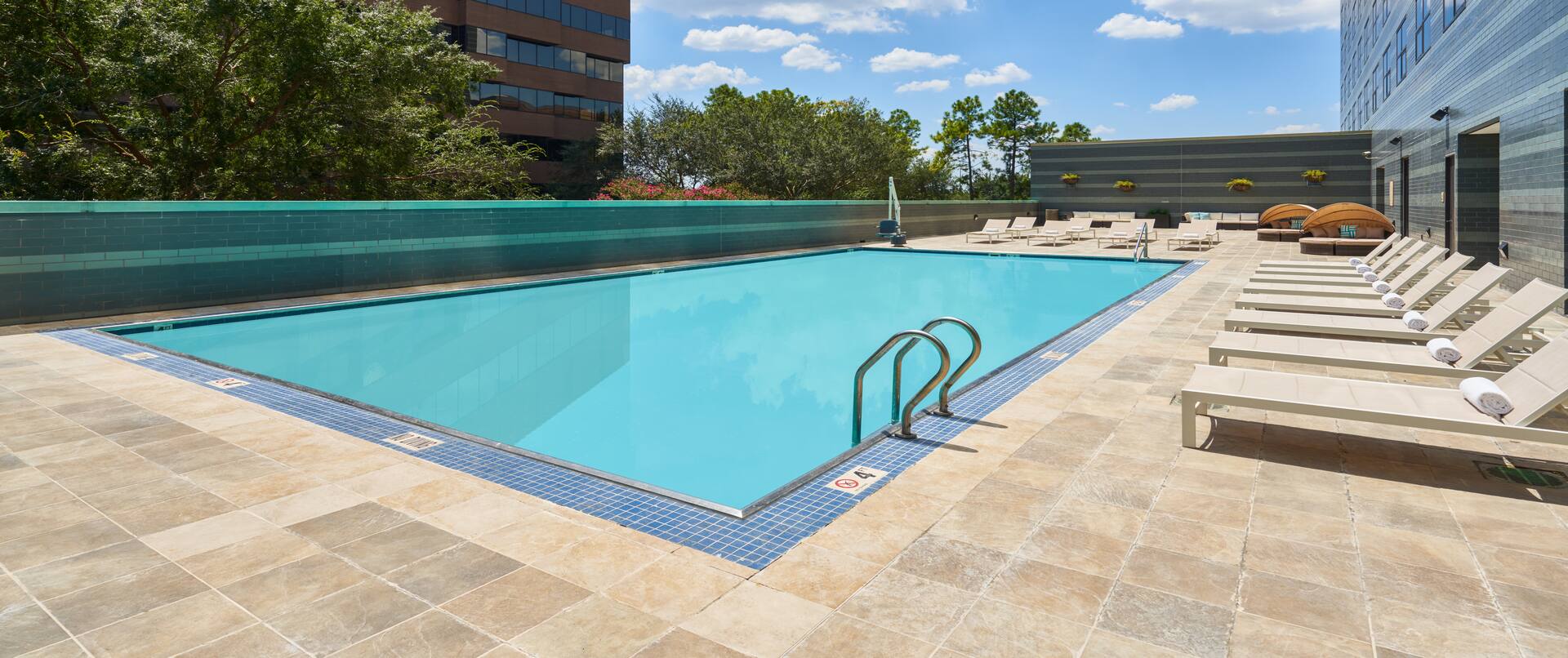 Outdoor pool area with loungers