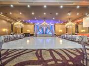 Ballroom with dancefloor and tables with chairs
