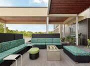 Outdoor lounge area for guests to relax with comfortable sofa style seating and firepit.