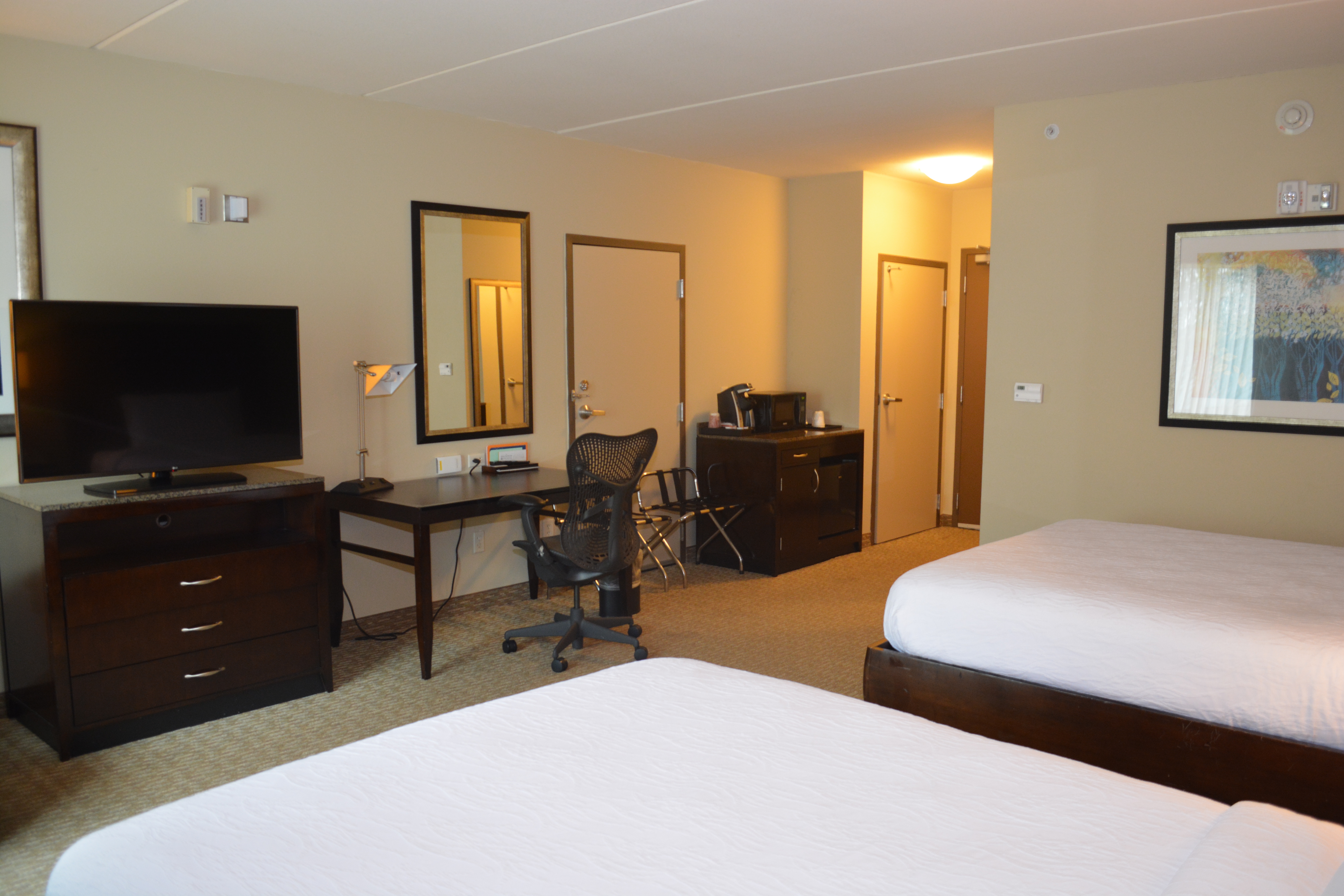 Two Queen-Size Beds, TV, Work Desk with Chair, Microwave, and Mini-Fridge in Accessible Guest Room