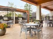 Outdoor Patio Area with Chairs, Tables, Umrella and Shelter